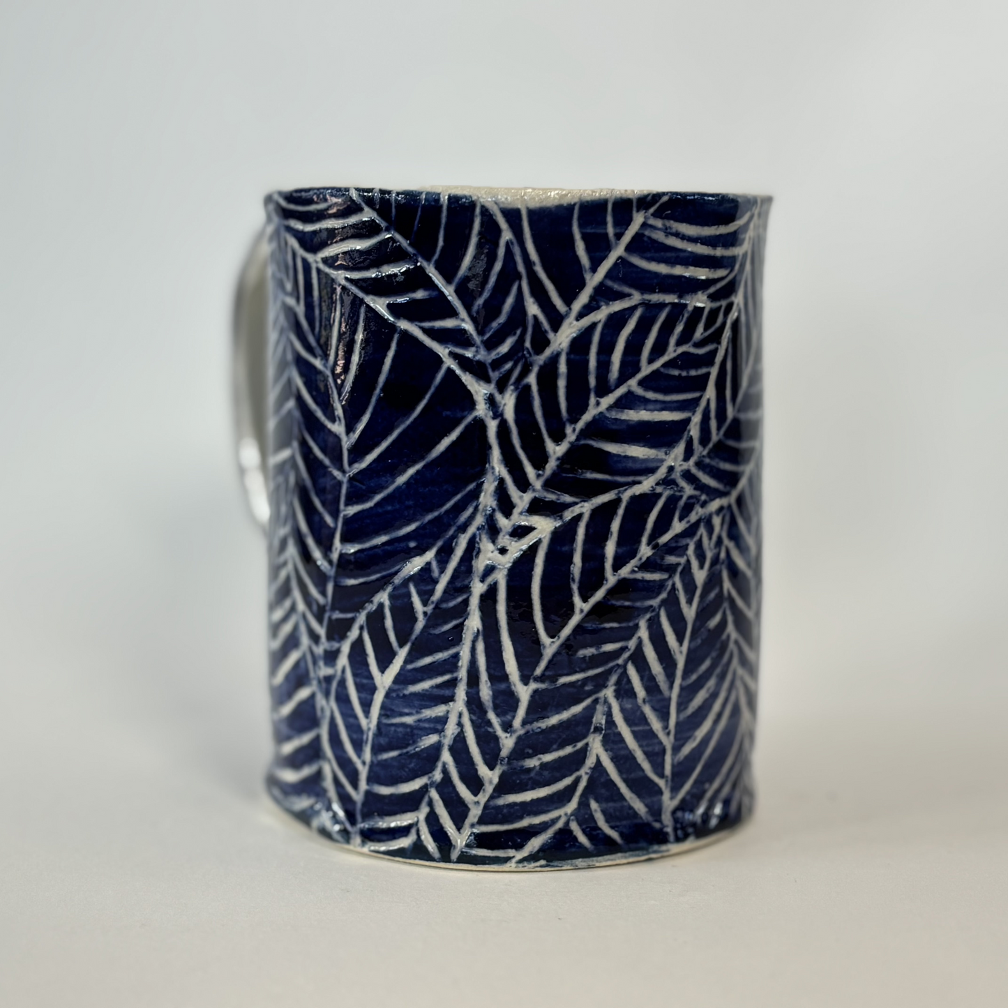 Handcrafted Stoneware Mug - Dark Blue Hand-Painted Leaves