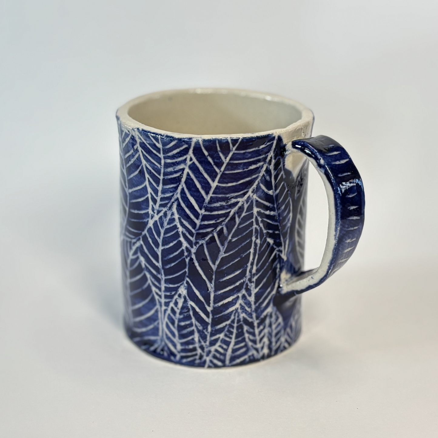 Handcrafted Stoneware Mug - Dark Blue Hand-Painted Leaves